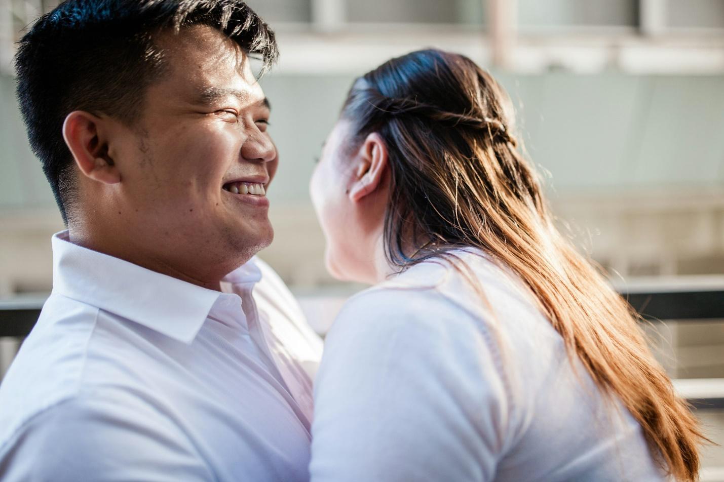 Man in the white polo shirt kisses woman in a white shirt